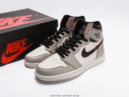 A pair of grey, white, and black high-top sneakers next to a black box.