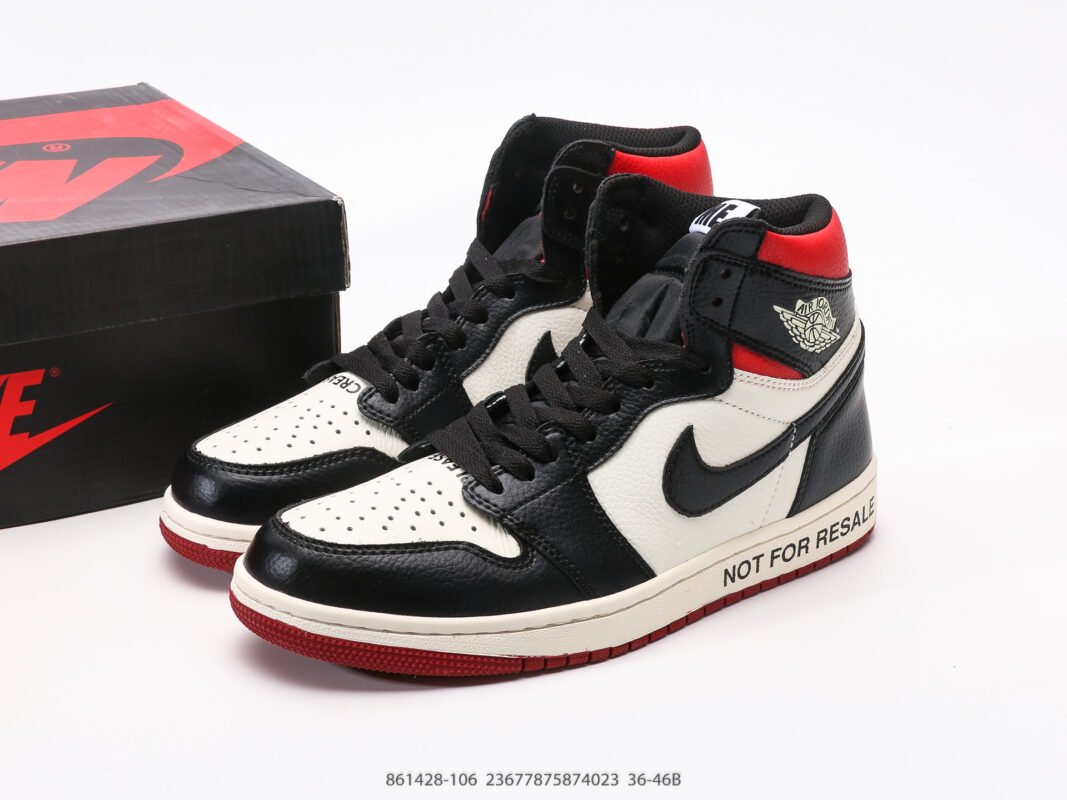 A pair of red, black, and white high-top sneakers with text on the side, next to a black box.