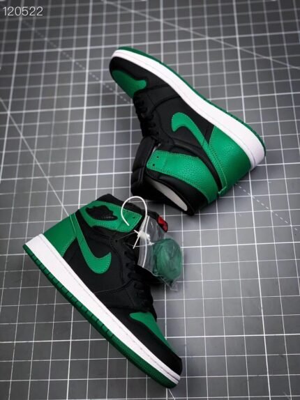A pair of green and black high-top sneakers on a grid background.