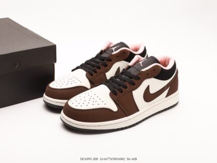 A pair of brown and black sneakers next to a black shoebox.