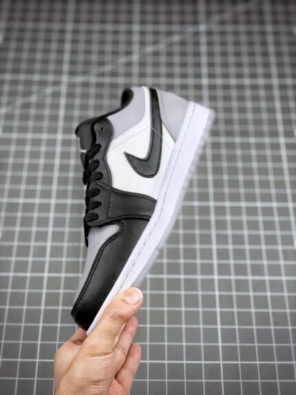 Black and white sports shoes with a checkmark logo on the side.