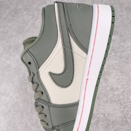 A gray and white Nike shoe with the Nike logo on the side.