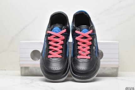 Black sneakers with pink laces and blue interior.