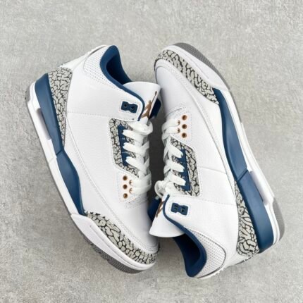 White sports shoes with blue and snake skin texture accents, white laces
