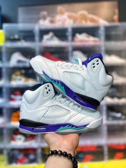 High-top sneakers in white with purple and teal accents.