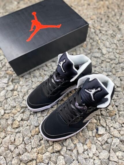 Black sneakers with white soles, red logo, black shoebox