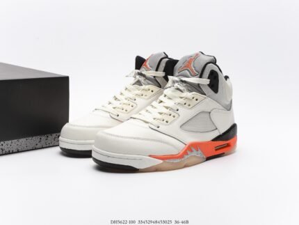 White sneakers with orange and grey details, black shoebox