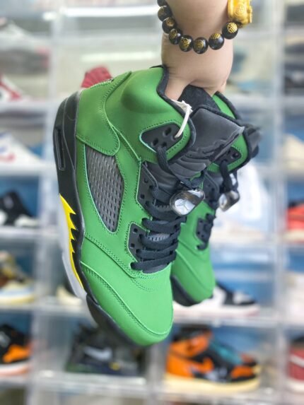 Green high-top sneaker with black laces and yellow accents.