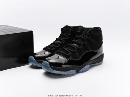 A pair of black high-top sneakers with a glossy upper and transparent sole, next to a black shoebox.