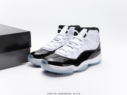 A pair of black and white high-top sneakers next to a black shoebox.