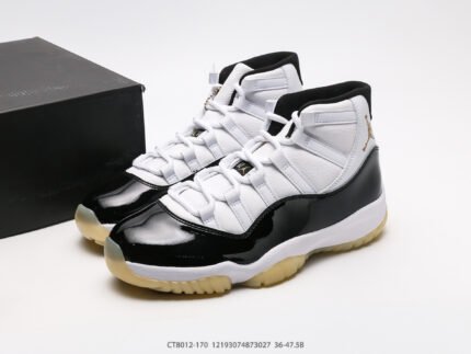 A pair of black and white high-top sneakers next to a black shoebox.