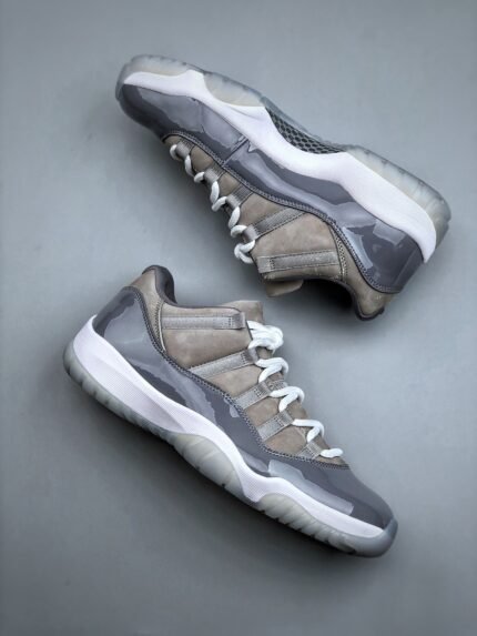 A pair of gray sneakers with unique textures and design details.