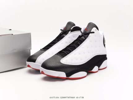 Black and white sports shoes, red sole, black laces