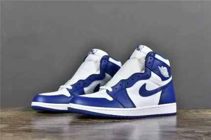 A pair of blue and white high-top sneakers against a grey and wooden floor background.