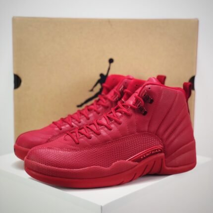 Red high-top sports shoes with lace-up closure, brown background