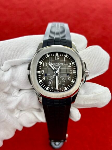 A black-faced wristwatch with a silver bezel and a black rubber strap.