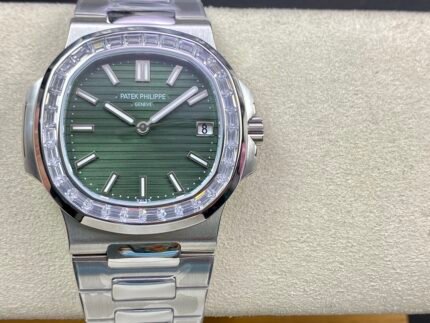 A green-faced wristwatch with a silver bezel and a silver metal bracelet.