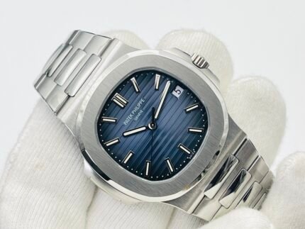 A blue-faced wristwatch with a silver bezel and a silver metal bracelet.