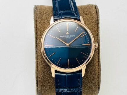 A watch with a blue dial, gold hands, and a dark leather strap.