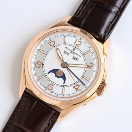 A gold-colored watch with a white dial, blue hands, and a moon phase indicator, featuring a brown leather strap.