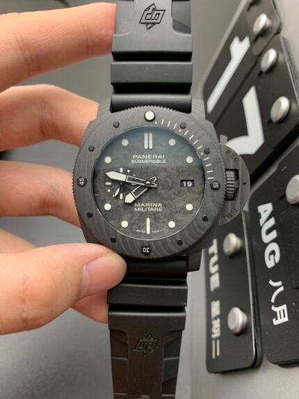 A person holding a black wristwatch with a black dial and date display on a black strap.