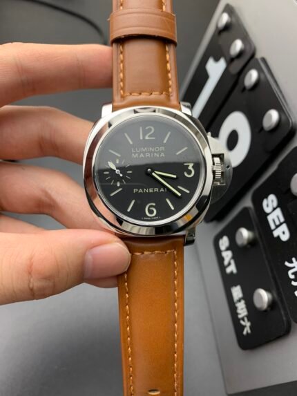 A brown leather strap wristwatch with a white dial and black markers.