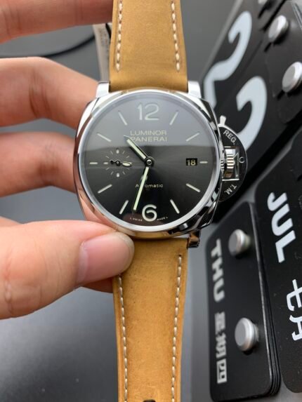 A black wristwatch with a tan leather strap and white markers.