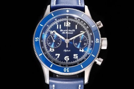 A watch with a silver case, blue dial, and blue strap, featuring multiple sub-dials and white numerals.