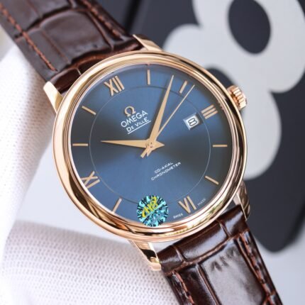 A gold watch with a blue dial and brown leather strap featuring a date window.