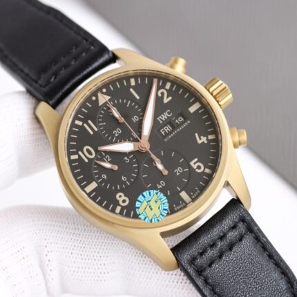 A gold-toned wristwatch with a black dial and leather strap.
