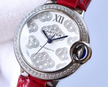 A white dial watch with star patterns and a red leather strap.