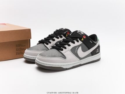 A pair of gray and black Nike Dunk Low sneakers with a shoebox in the background.