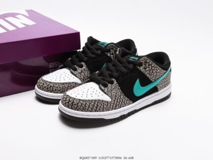 A pair of Nike Dunk Low sneakers with a crackle pattern and turquoise Swoosh, next to a purple shoebox.