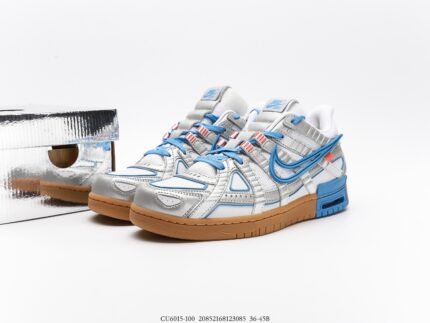 A pair of gray and blue Nike sneakers with a silver shoebox.