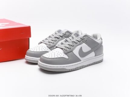 A pair of gray Nike Dunk Low sneakers with a red shoebox.