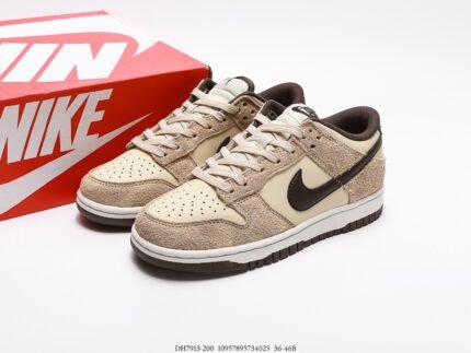 A pair of beige and brown Nike Dunk Low sneakers next to a red Nike shoebox.