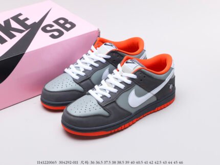 Grey and white sneakers with orange lining and soles, pink shoebox