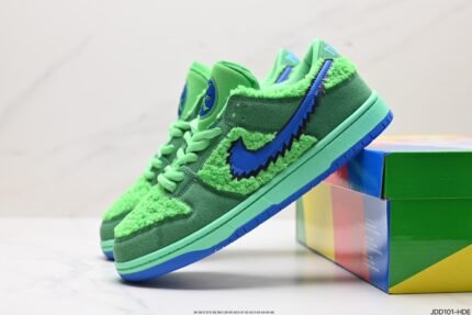 Green Nike Dunk Low sneakers with a cartoon character on the tongue and a colorful shoebox.