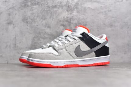 Gray Nike Dunk Low Pro sneaker with orange accents on a gray background.
