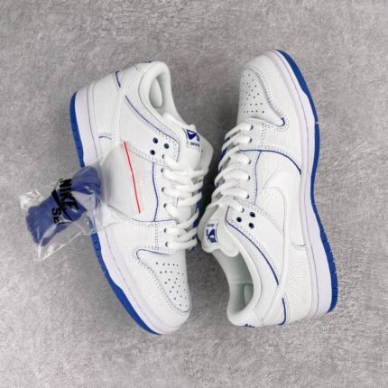 White and blue Nike SB Dunk Low Pro sneakers on a gray background with extra laces.