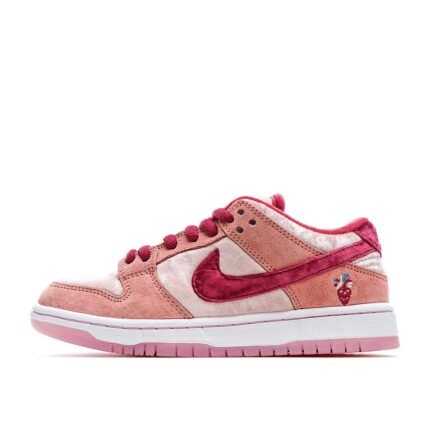 Pink Nike Dunk Low sneakers with a white background.