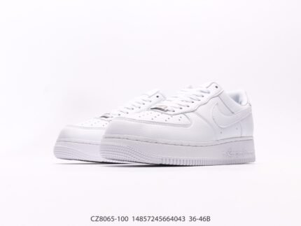 A pair of white sports shoes with a minimalist design