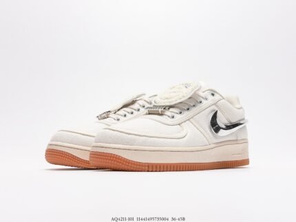 White sports shoes with black detail accents and a brown sole