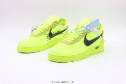 A pair of bright yellow sports shoes with black detail accents and a flat sole