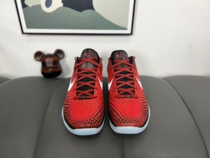 A pair of red sports shoes with black laces and a white sole