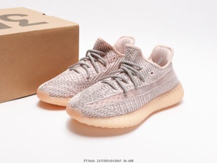 Pink sports shoes with light-colored details, next to a shoebox.