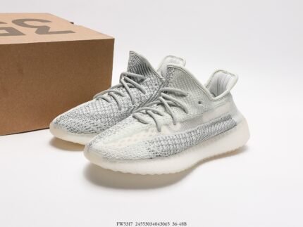 White sports shoes with light-colored details, next to a shoebox.