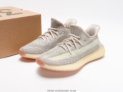 Beige sports shoes with light-colored details, next to a shoebox.