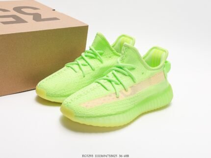 The image features a pair of neon green sneakers with a Primeknit upper that showcases a seamless, one-piece design enhancing breathability and comfort. The laces are also neon green, matching the upper for a vibrant and energetic overall look. The sole is made of translucent neon green Boost material, which is highly regarded for its superior energy return and cushioning. The modern and stylish design of these shoes makes them a great choice for consumers looking for a bold and fashionable statement, suitable for both everyday wear and sports activities.