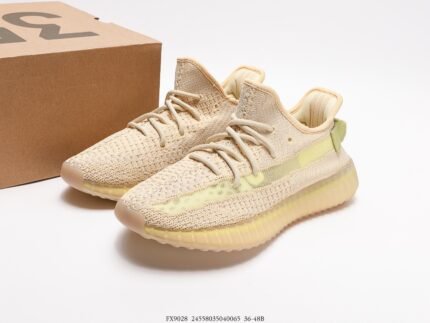 The image shows a pair of off-white sneakers with a Primeknit upper that offers excellent breathability and a snug fit. The laces are color-coordinated with the upper, creating a harmonious visual effect. The sole is translucent light yellow and features Boost technology, which is renowned for its superior cushioning and energy return. The modern and stylish design of these shoes makes them suitable for casual everyday wear and provides the comfort and performance needed for sports activities.